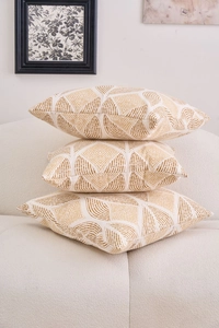 Close-up of three beige cotton linen pillow covers with yellow geometric diamond patterns