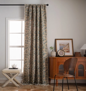 Detail of floral jacquard curtain with beige tassel trim in a vintage boho room