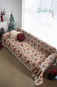 Close-up detail of Christmas themed throw cover with festive patterns and white fringe edge