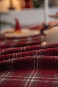 Detail of red and white plaid thick wool fabric texture for festive holiday table runner