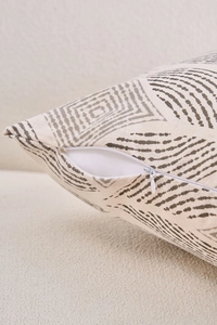 Detail of invisible zipper closure and geometric print on a linen texture pillow cover