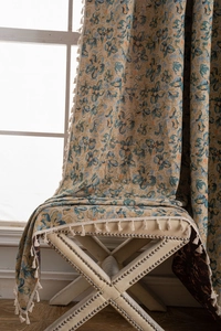 Close-up of vintage floral jacquard fabric texture with elegant beige tassels detail