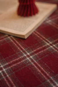 Close-up of thick red and gray plaid woolen fabric texture for festive table runners