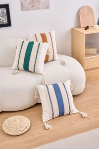 Detailed close-up of woven cotton linen pillow covers with tassels in bohemian style