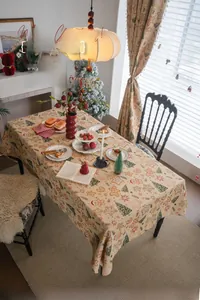 Detail of Christmas tablecloth with gingerbread man and pine tree patterns on linen fabric