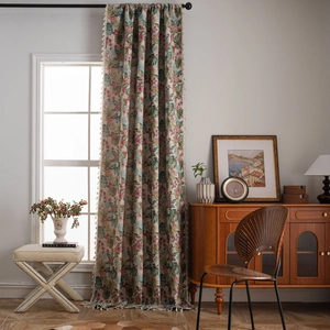 Floral curtains with tropical birds and beige tassels in a sunny vintage room setting