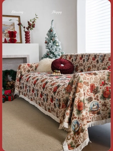 Close-up of thick jacquard Christmas throw blanket with festive patterns and white fringes
