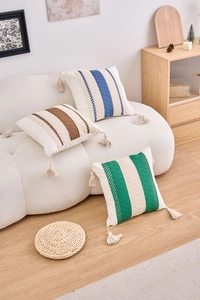 Close-up of geometric woven pillowcase with colored stripes and corner tassels decor