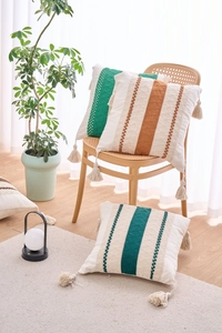 Detailed view of bohemian pillowcase fringe and emerald green woven stripe texture