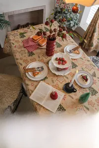 Macro detail of gingerbread man and Santa motifs on Christmas jacquard tablecloth