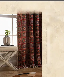 Detail of red geometric jacquard curtain fabric with vintage cotton weave and white fringe