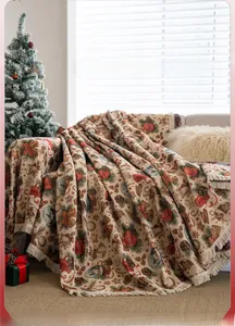 Detailed close-up of woven Christmas throw blanket with festive patterns and fringe edges
