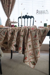 Detailed jacquard fabric texture with Christmas tree and bell patterns on festive tablecloth