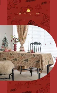 Detail of jacquard gingerbread man and Christmas tree patterns on festive tablecloth