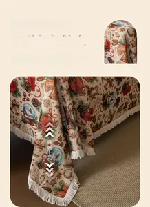 Close-up of vintage Christmas sofa cover with jacquard festive patterns and white fringe