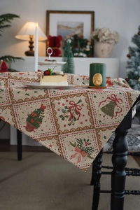 Detailed close-up of Christmas jacquard tablecloth with festive patterns and scalloped edges