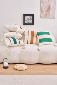 Detailed texture of woven cotton linen pillowcase with stripes and boho fringe tassels