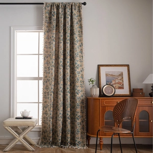 Floral jacquard curtains with vintage bird pattern and cream tassel fringe in a cozy room