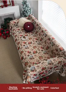 Close-up of Christmas jacquard sofa cover featuring festive patterns and tassel fringe edge