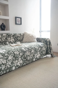 Detail of dark green floral sofa cover with jacquard fabric and vintage pattern