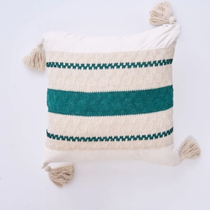 Detailed close-up of bohemian woven pillow cover with decorative corner tassels