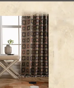 Close-up of geometric jacquard curtain fabric with woven squares and tassel fringe detail