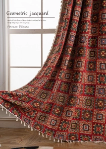 Close-up of red geometric jacquard curtains featuring relief texture and white tassel fringe