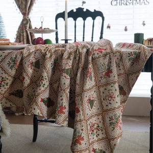 Christmas jacquard tablecloth with festive bells and red bows on a black dining table