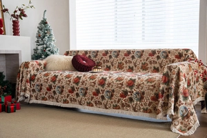 Close-up of thick knitted Christmas sofa cover with jacquard holiday pattern and fringe trim