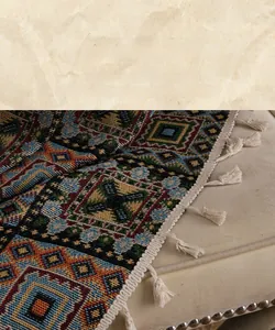 Detail of geometric jacquard fabric with handmade cream tassels in American vintage style