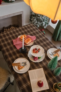 Nappe à carreaux marron dans un décor de Noël chaleureux avec des décorations festives