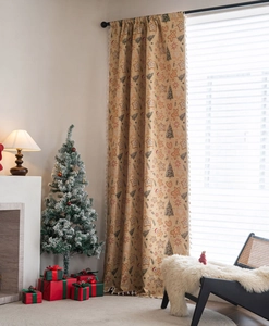 Detail of Christmas gingerbread man and tree pattern curtain with white fringe balls