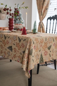 Close-up of festive Christmas tablecloth with gingerbread men and snowflake patterns