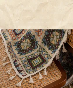 Detailed view of bohemian jacquard geometric fabric with elegant white tassel fringe