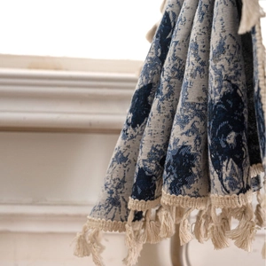 Blue and white geometric jacquard curtain with elegant fringe trim and floral pattern