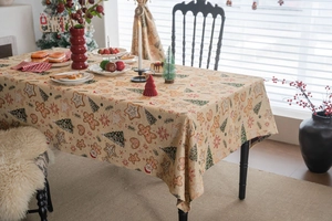 Macro view of Christmas jacquard tablecloth fabric with gingerbread man and tree pattern