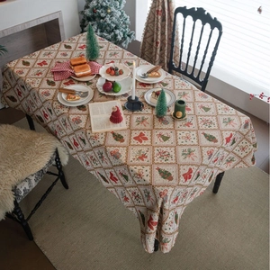 Christmas rectangular tablecloth with festive trees bows and bells on a dining table