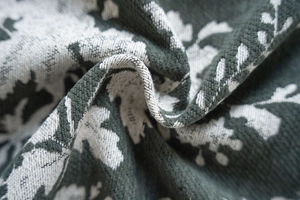 Detailed macro view of the jacquard fabric texture and white floral patterns