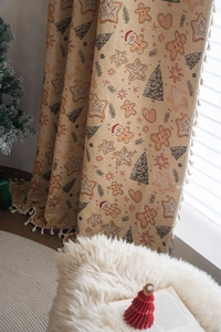 Detail of Christmas gingerbread man and tree jacquard fabric with elegant white tassels