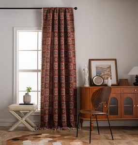 Close-up of geometric jacquard fabric curtains with colorful patterns and white tassels