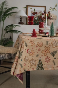 Detail of Christmas tablecloth fabric with gingerbread man and pine tree jacquard patterns