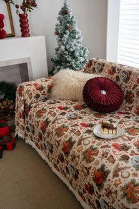 Christmas jacquard throw blanket detail with bows, pine cones, and festive tassels