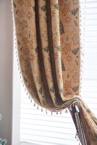Detail of Christmas jacquard curtain with gingerbread man patterns and white fringe trim