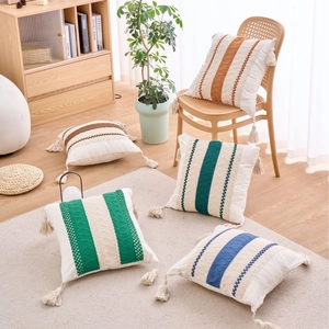 Modern geometric accent pillows with colorful woven stripes and tassels for home sofa decor