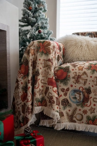 Detail of Christmas throw blanket with bells and gingerbread man jacquard patterns