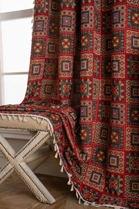 Detail of red geometric jacquard fabric with ethnic patterns and white fringe tassels