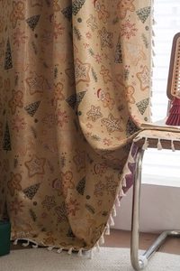 Close-up of Christmas gingerbread man and tree pattern on fabric with fringe edges