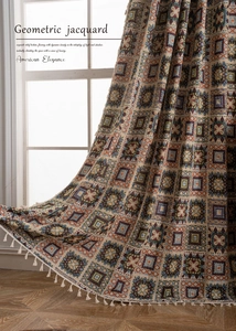 Detail of geometric jacquard curtain fabric with white fringe trim and elegant patterns