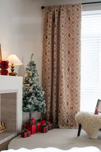 Close-up of Christmas curtains with red and green bells, festive patterns, and fringe trim