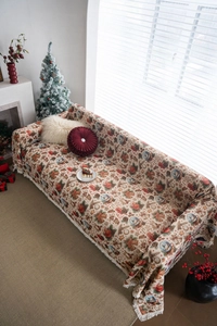 Detail of festive Christmas jacquard sofa cover with thick knit fabric and tassel edges
